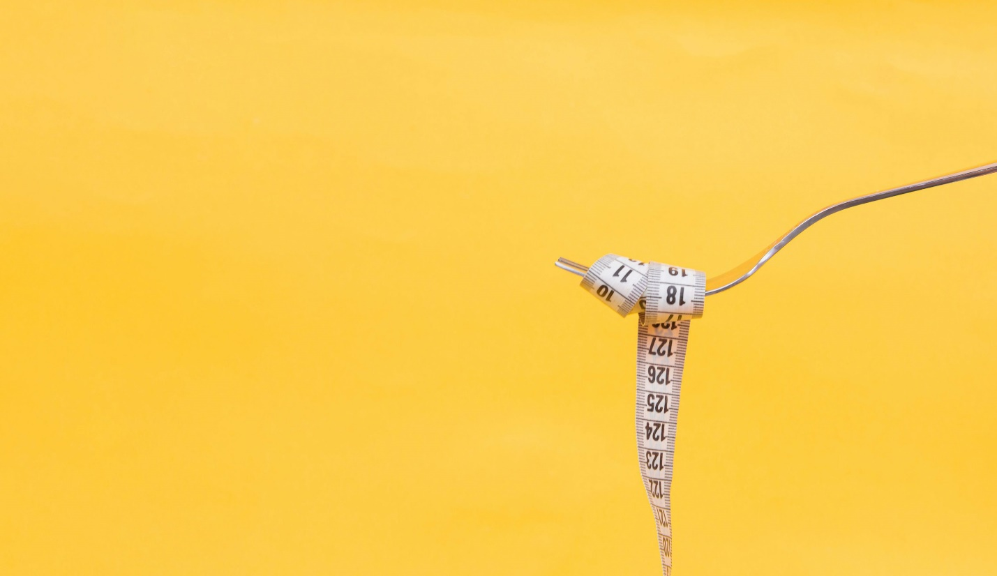 A fork wrapped with a measuring tape after using Ozempic for weight loss