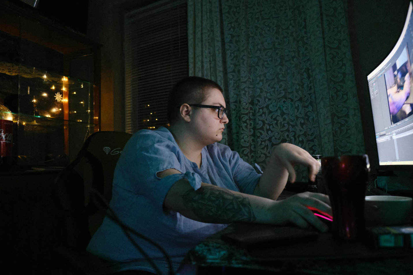 An obese person uses a computer.